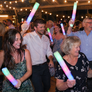 Guests of all ages dancing with LED glow sticks