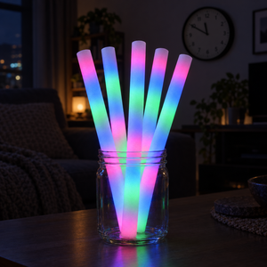 Five multicolour foam glow sticks glowing in a jar